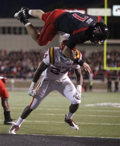 Texas Tech's Seth Doege (7) dives for a touchdown over Iowa State's Durrell Givens (24) during an NCAA college football game, in Lubbock, Texas, Saturday, Oct. 29, 2011. (AP Photo/Lubbock Avalanche-Journal, Stephen Spillman)