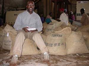 Cofffee Bean Locations: Kenya - Man sitting on bags of Kenyan coffee